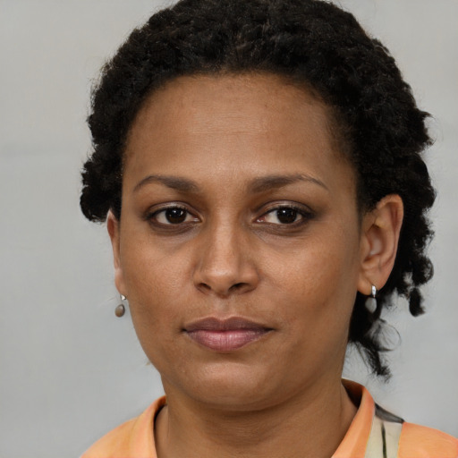 Neutral black adult female with short  brown hair and brown eyes