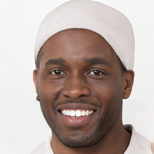 Joyful black young-adult male with short  black hair and brown eyes