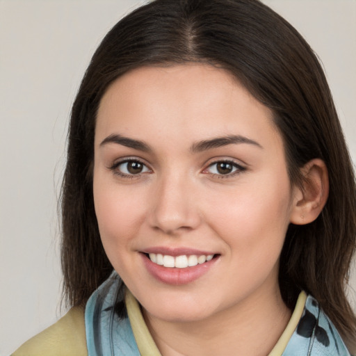 Joyful white young-adult female with medium  brown hair and brown eyes