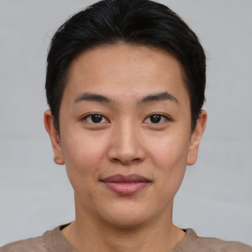Joyful asian young-adult female with short  brown hair and brown eyes