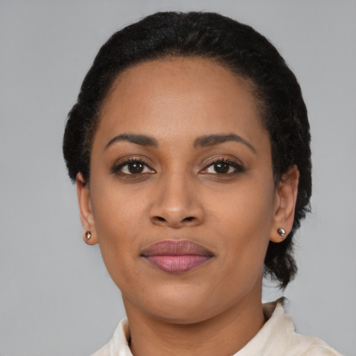 Joyful latino young-adult female with short  black hair and brown eyes