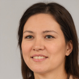 Joyful white young-adult female with medium  brown hair and brown eyes