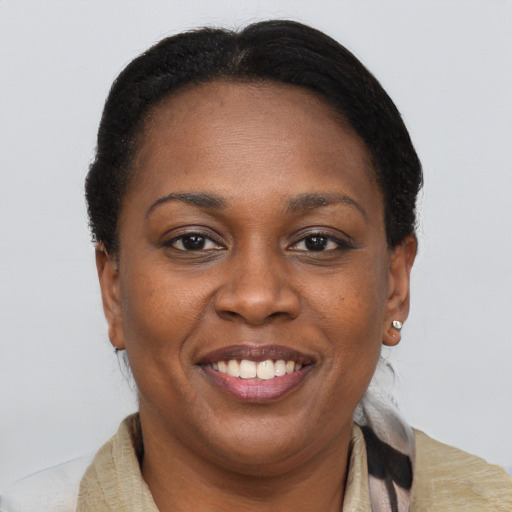 Joyful black adult female with short  brown hair and brown eyes