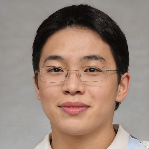 Joyful asian adult male with short  brown hair and brown eyes