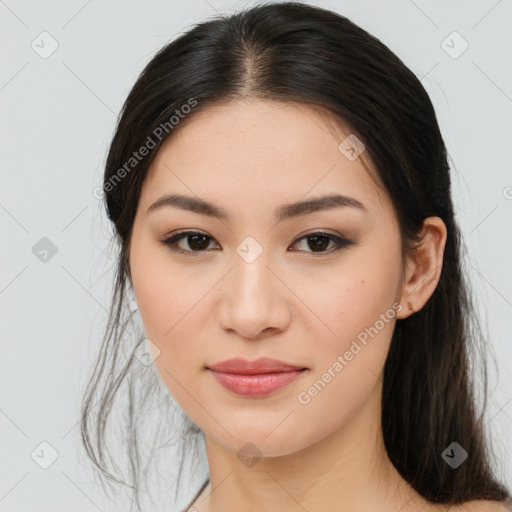 Joyful asian young-adult female with long  brown hair and brown eyes