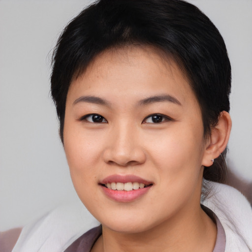 Joyful asian young-adult female with short  brown hair and brown eyes