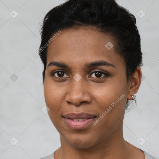 Joyful black young-adult female with short  black hair and brown eyes