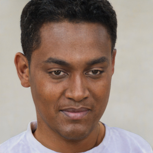 Joyful black young-adult male with short  black hair and brown eyes