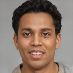 Joyful latino young-adult male with short  brown hair and brown eyes