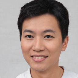 Joyful asian young-adult male with short  brown hair and brown eyes