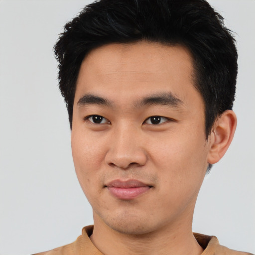 Joyful asian young-adult male with short  black hair and brown eyes