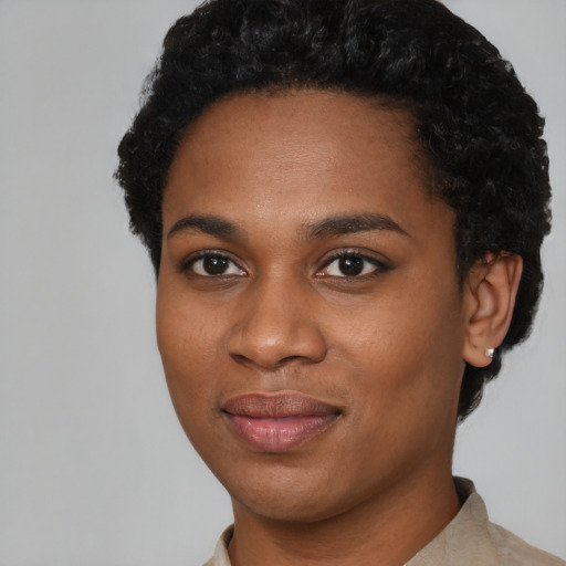 Joyful black young-adult female with short  black hair and brown eyes