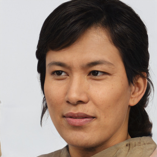 Joyful asian young-adult male with medium  brown hair and brown eyes