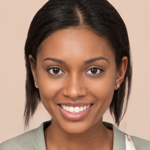 Joyful black young-adult female with long  brown hair and brown eyes