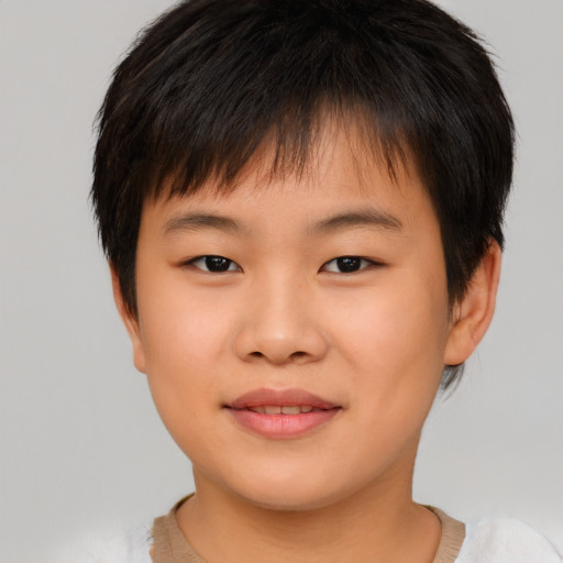 Joyful asian child male with short  brown hair and brown eyes