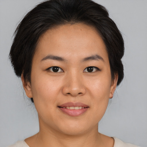Joyful asian young-adult female with medium  brown hair and brown eyes