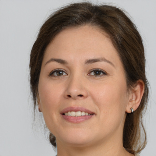 Joyful white young-adult female with medium  brown hair and brown eyes