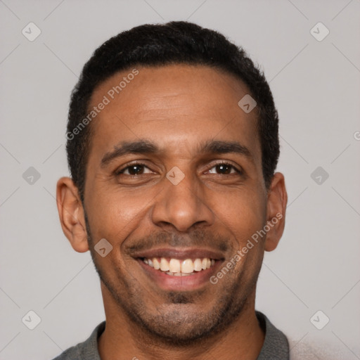 Joyful latino young-adult male with short  black hair and brown eyes