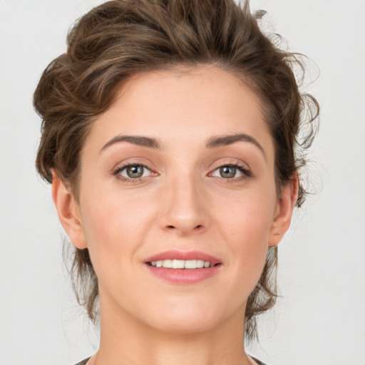 Joyful white young-adult female with medium  brown hair and green eyes