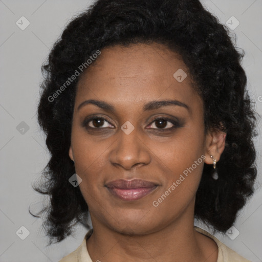 Joyful black young-adult female with long  black hair and brown eyes