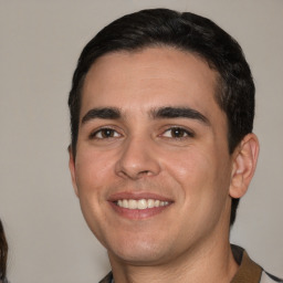 Joyful white young-adult male with short  black hair and brown eyes