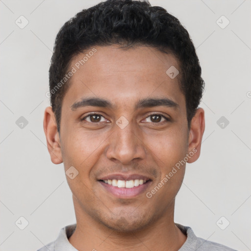 Joyful latino young-adult male with short  brown hair and brown eyes