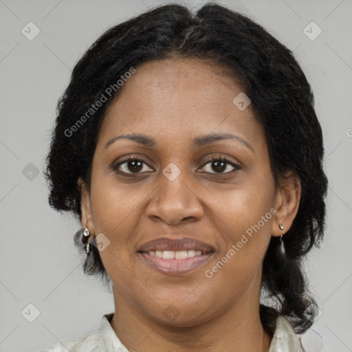 Joyful black adult female with medium  brown hair and brown eyes