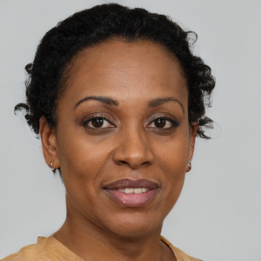 Joyful black adult female with short  brown hair and brown eyes