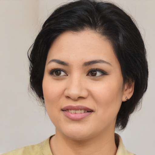 Joyful asian young-adult female with medium  brown hair and brown eyes