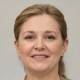 Joyful white adult female with medium  brown hair and grey eyes