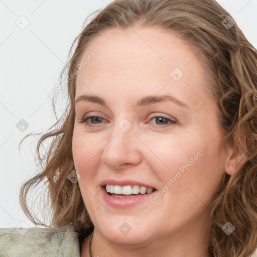 Joyful white young-adult female with medium  brown hair and blue eyes