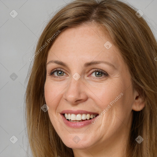 Joyful white adult female with long  brown hair and green eyes