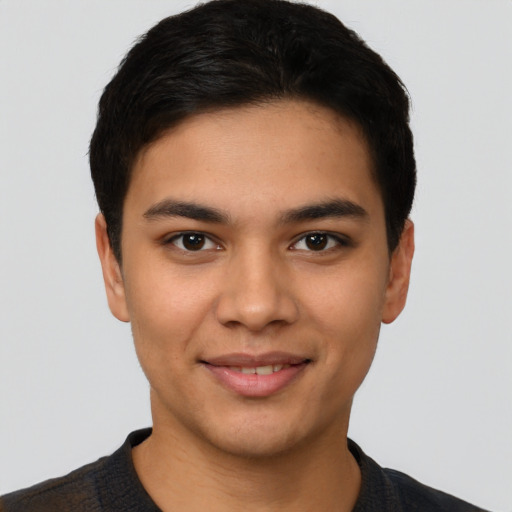 Joyful latino young-adult male with short  black hair and brown eyes