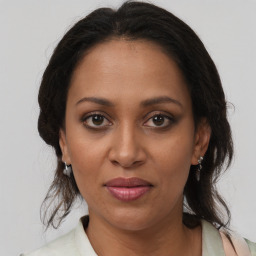 Joyful black adult female with medium  brown hair and brown eyes