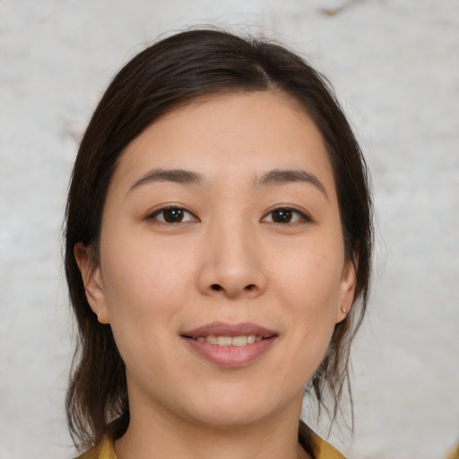 Joyful white young-adult female with medium  brown hair and brown eyes