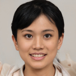 Joyful asian young-adult female with medium  black hair and brown eyes