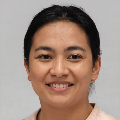 Joyful asian young-adult female with short  brown hair and brown eyes