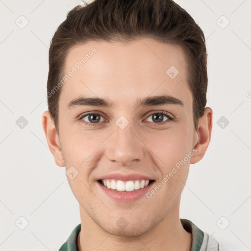 Joyful white young-adult male with short  brown hair and grey eyes