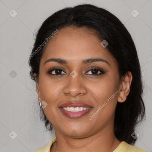 Joyful black young-adult female with long  black hair and brown eyes