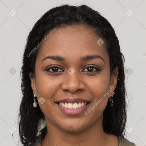 Joyful black young-adult female with long  brown hair and brown eyes