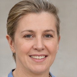 Joyful white adult female with short  brown hair and grey eyes