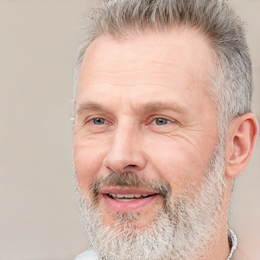 Joyful white middle-aged male with short  gray hair and brown eyes