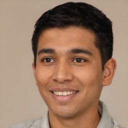 Joyful latino young-adult male with short  black hair and brown eyes