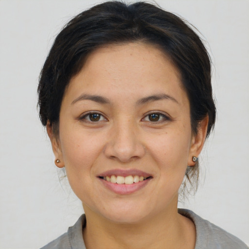 Joyful asian young-adult female with medium  brown hair and brown eyes