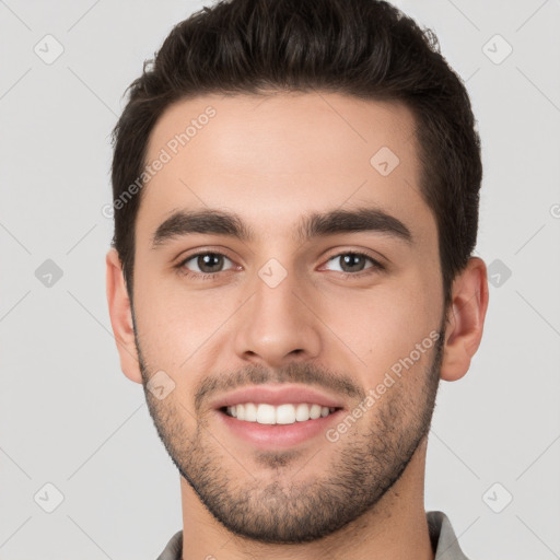 Joyful white young-adult male with short  brown hair and brown eyes