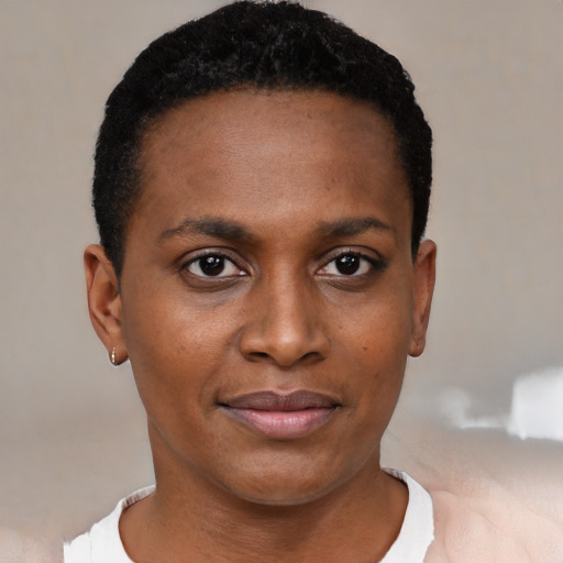 Joyful black young-adult female with short  black hair and brown eyes