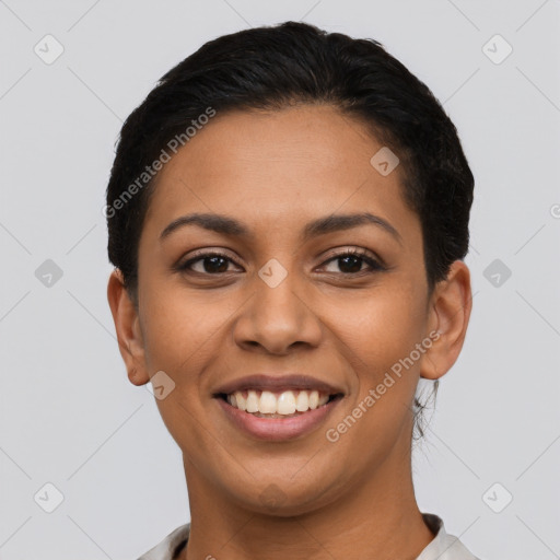 Joyful latino young-adult female with short  black hair and brown eyes