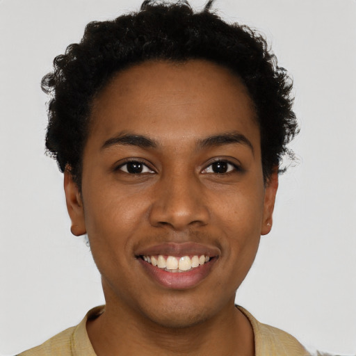 Joyful black young-adult female with short  brown hair and brown eyes