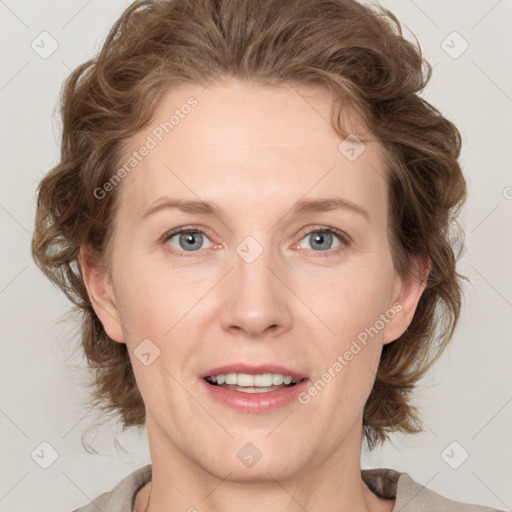 Joyful white adult female with medium  brown hair and blue eyes