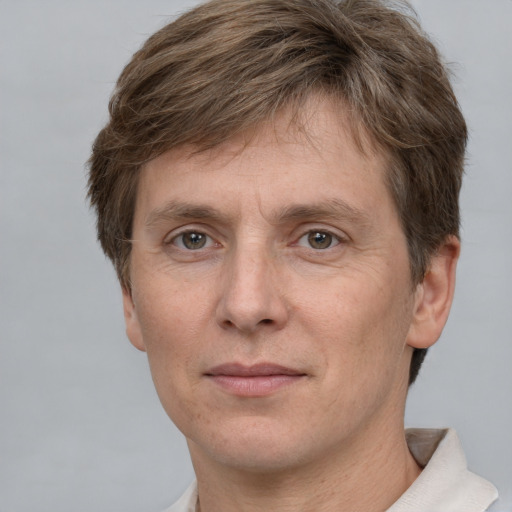 Joyful white adult male with short  brown hair and grey eyes